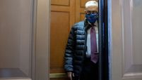 Senate Majority Leader Chuck Schumer, D-N.Y., wears a protective mask while departing the U.S. Capitol